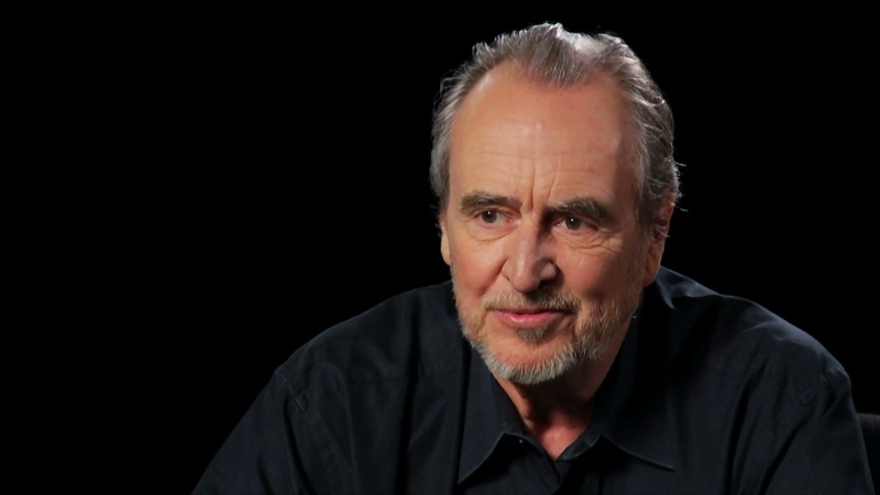 Wes Craven sits against a dark background