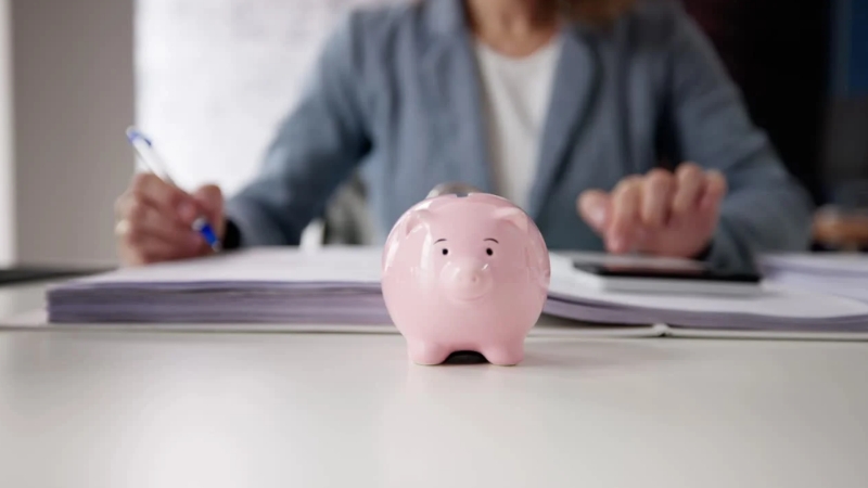 Pink piggy bank on a desk for Ohio business sales tax